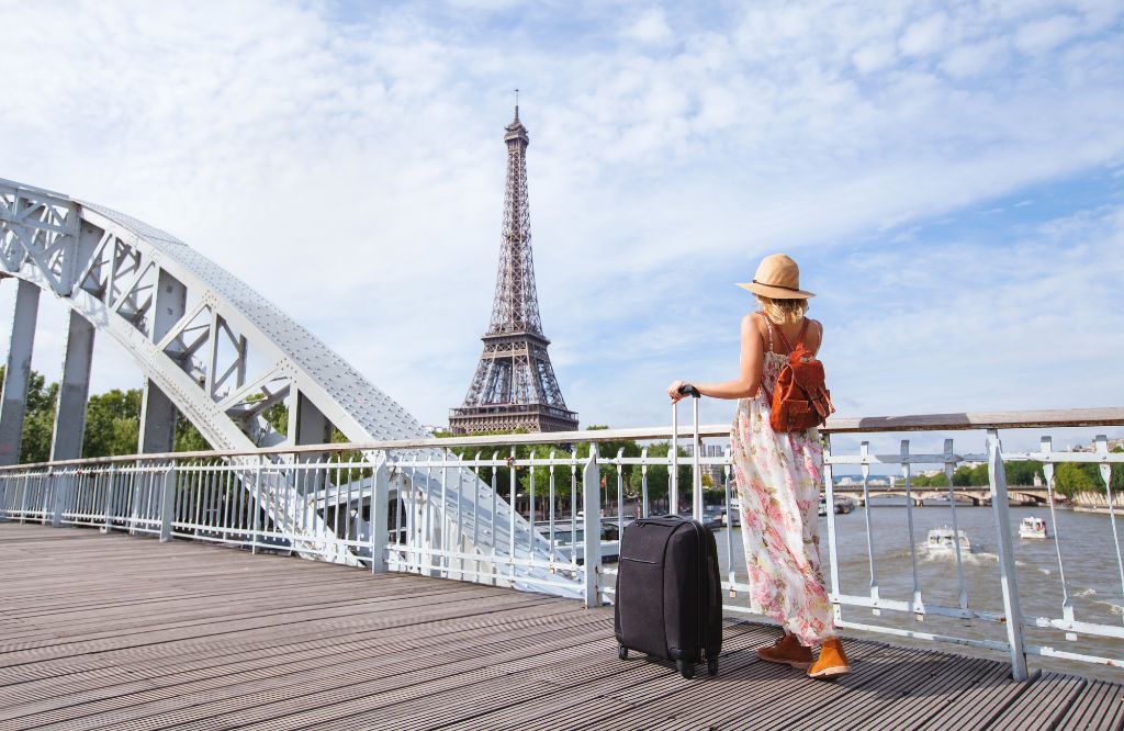 mulher em frente a torre eiffel esim frança